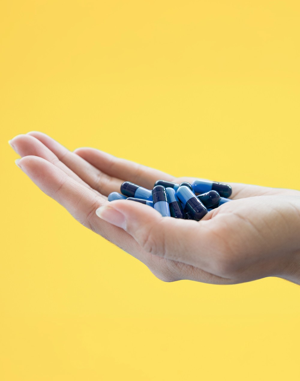 hand holding capsules hand holding capsules
